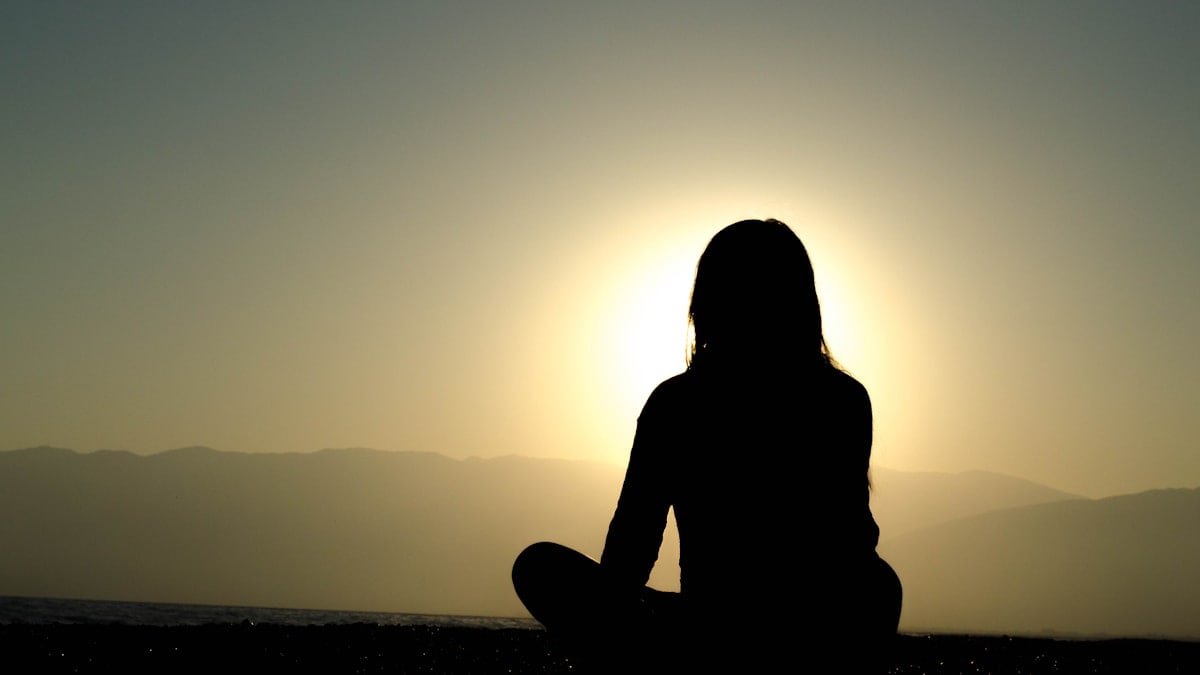 woman sitting on sand